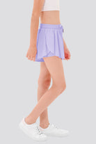 Side view of a girl wearing purple butterfly shorts